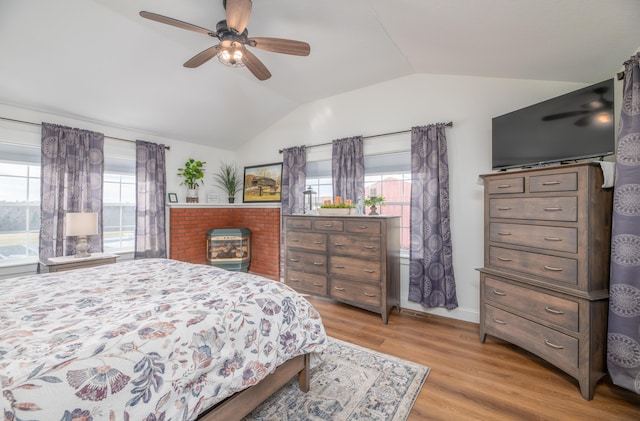 bedroom with ceiling fan, light hardwood / wood-style floors, multiple windows, and lofted ceiling