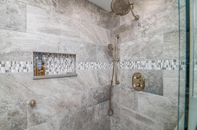 interior details featuring a tile shower