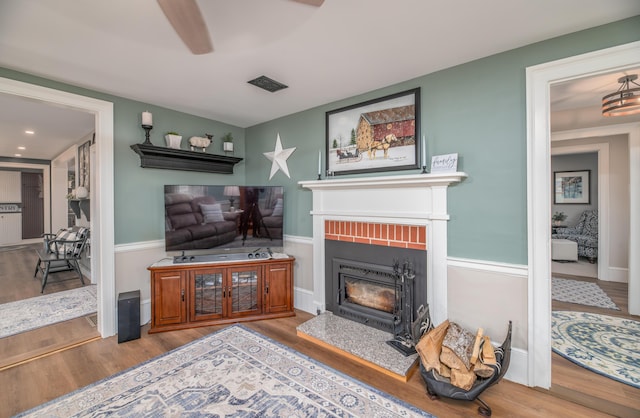 living room with ceiling fan and hardwood / wood-style flooring