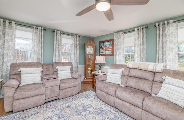 living room with ceiling fan, hardwood / wood-style floors, and a healthy amount of sunlight