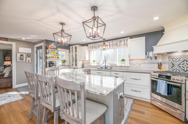 kitchen with white cabinetry, stainless steel appliances, and a kitchen island