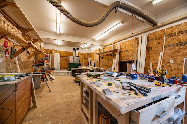 misc room featuring a workshop area and crown molding