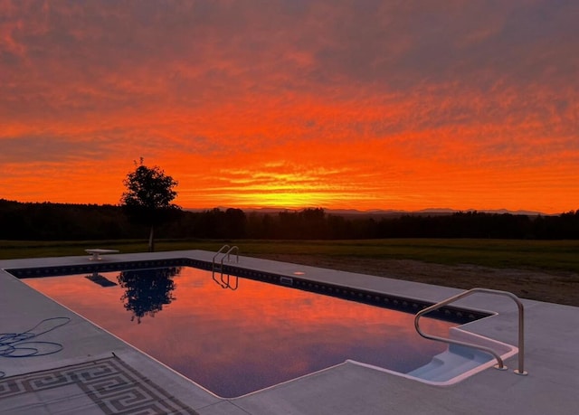 pool at dusk with a diving board