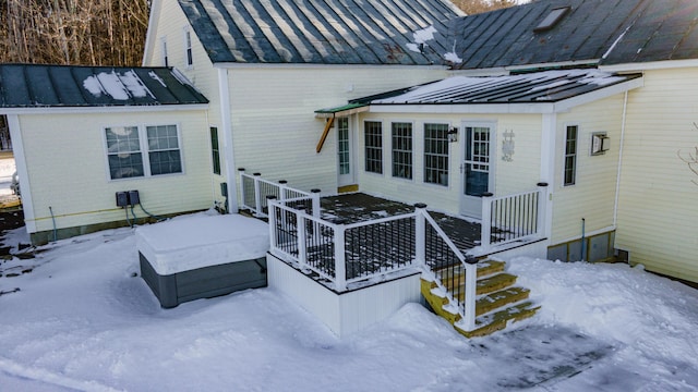 view of snow covered back of property