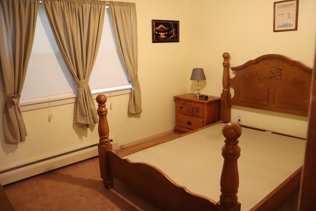 carpeted bedroom with a baseboard radiator