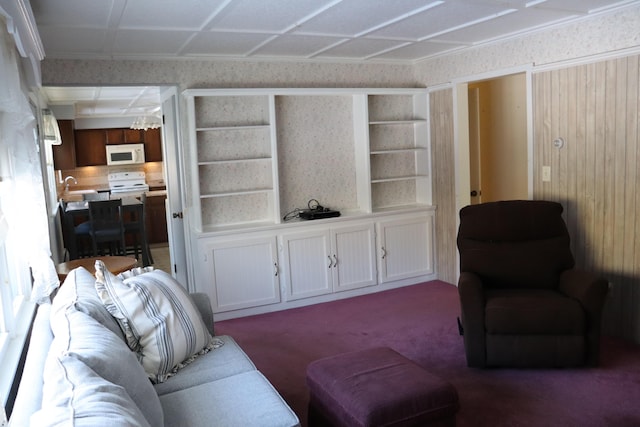 living room with carpet flooring, built in features, and sink