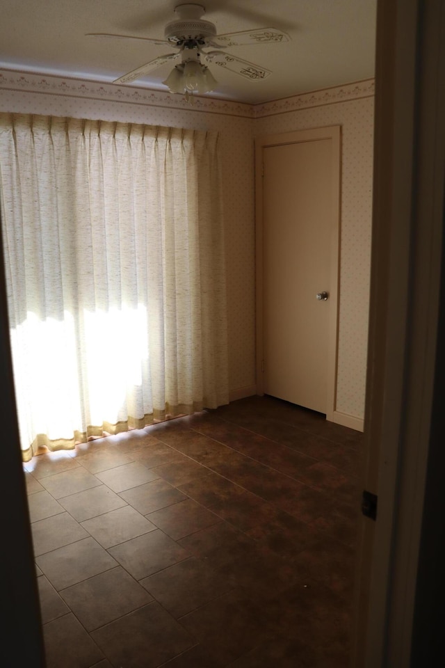 spare room with tile patterned flooring and ceiling fan