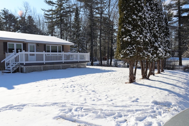 snowy yard with a deck