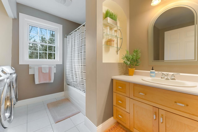 bathroom with tile patterned flooring, washing machine and dryer, vanity, and shower / bath combo