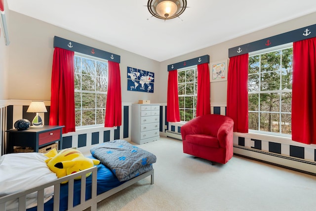 carpeted bedroom with multiple windows and baseboard heating