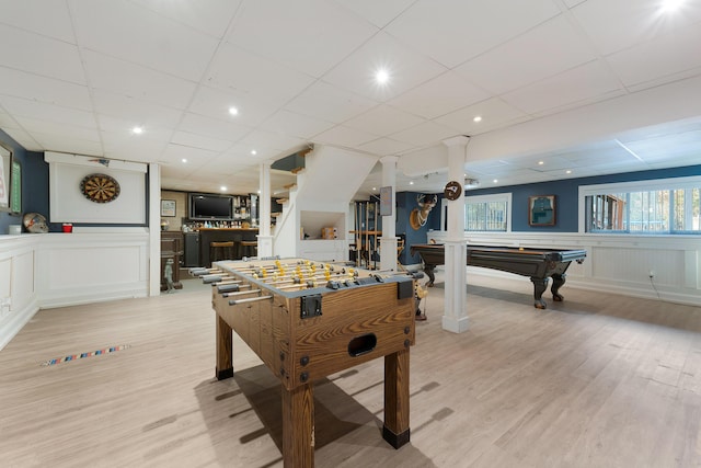 rec room with pool table, a drop ceiling, and light hardwood / wood-style flooring