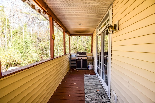 wooden deck featuring area for grilling