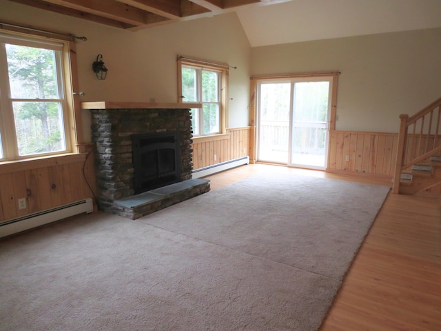 unfurnished living room with hardwood / wood-style flooring, a fireplace, beamed ceiling, and a baseboard radiator