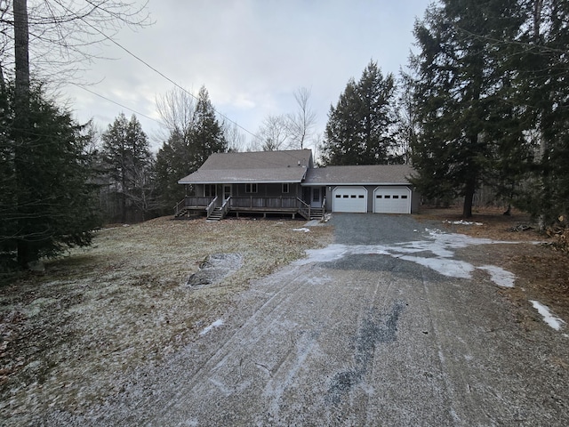 view of front of property featuring a garage and covered porch