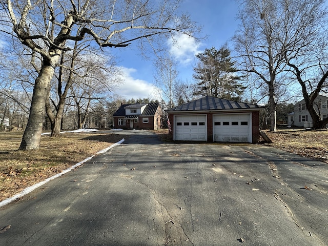 view of front of house featuring a garage and an outdoor structure