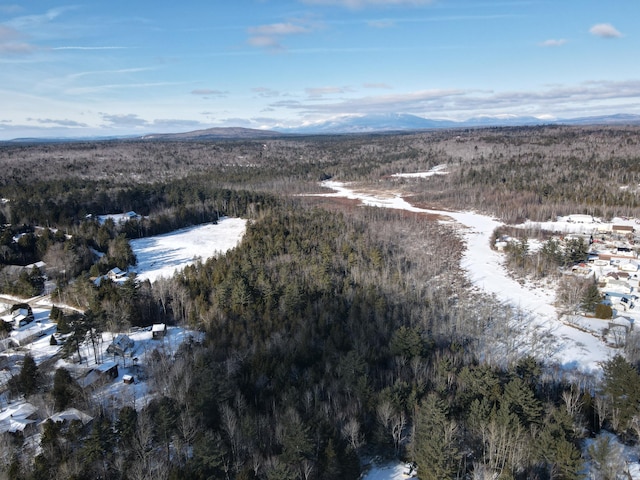 snowy aerial view with a mountain view