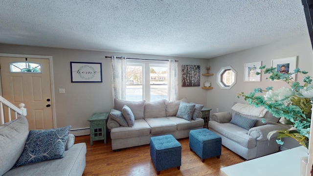 living room with a textured ceiling, hardwood / wood-style flooring, and a baseboard radiator