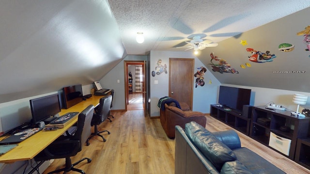 home office with lofted ceiling, ceiling fan, a textured ceiling, and light hardwood / wood-style flooring