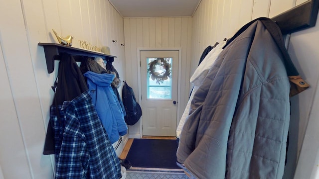 mudroom with wooden walls