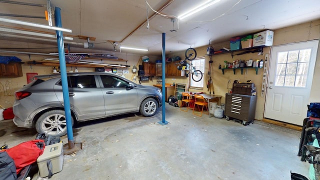 garage with a garage door opener and a workshop area