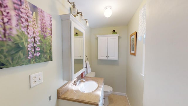 bathroom featuring toilet, vanity, and tile patterned flooring