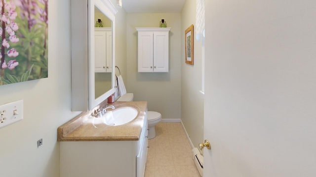 bathroom with toilet, baseboard heating, and vanity