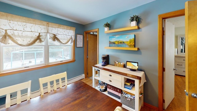 hall with hardwood / wood-style floors and a baseboard radiator