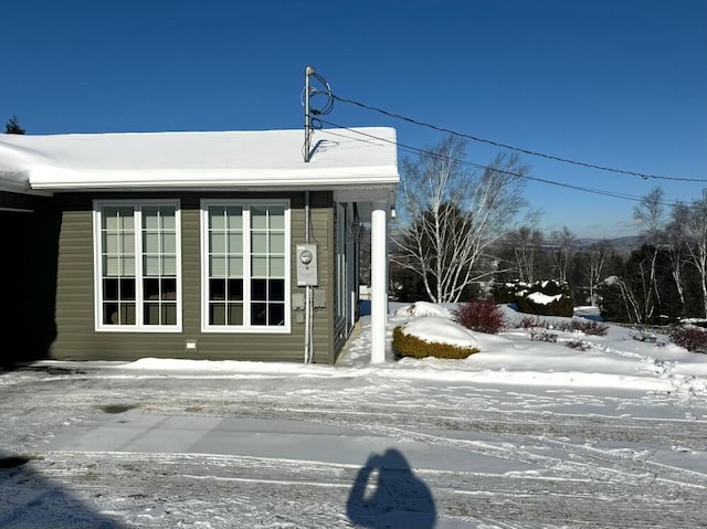 view of snow covered property entrance