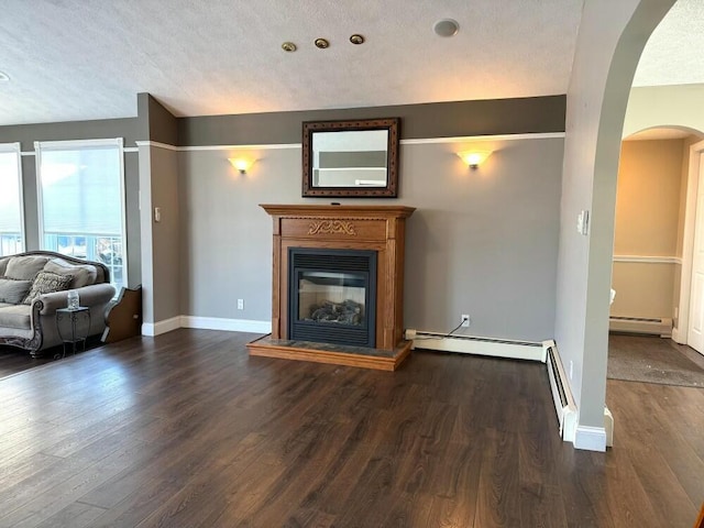 unfurnished living room featuring a textured ceiling, baseboard heating, and dark hardwood / wood-style flooring