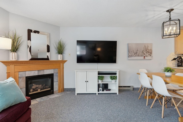 living room with light carpet, a baseboard radiator, a chandelier, and a tiled fireplace