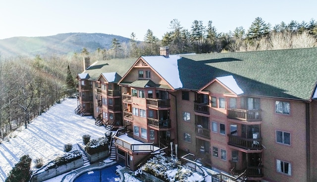 snowy aerial view featuring a mountain view