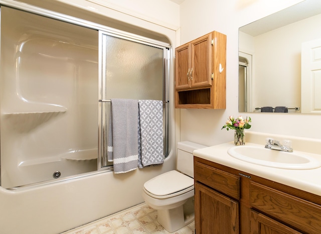 full bathroom featuring toilet, enclosed tub / shower combo, and vanity