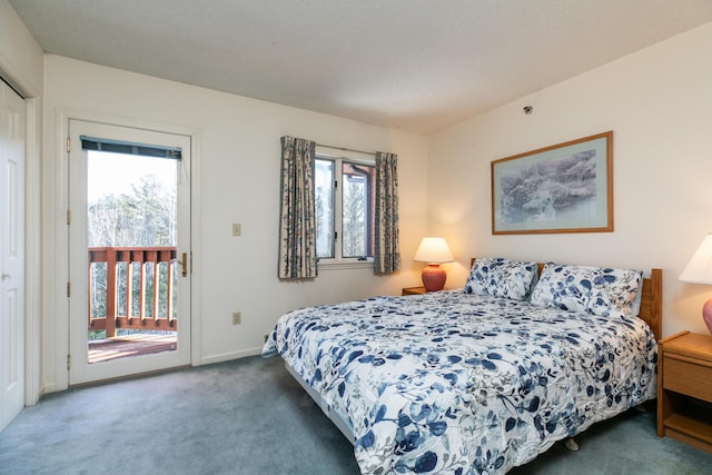 carpeted bedroom featuring multiple windows and access to outside