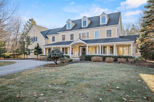 view of front of home featuring covered porch and a front yard