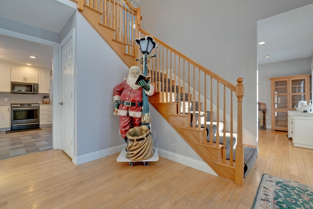 stairs featuring hardwood / wood-style flooring