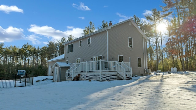 snow covered property with a deck