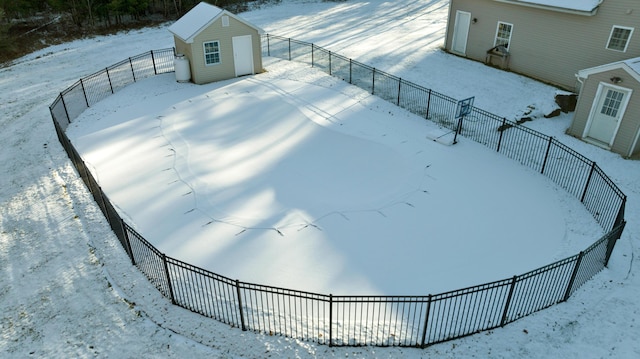 yard layered in snow with a shed