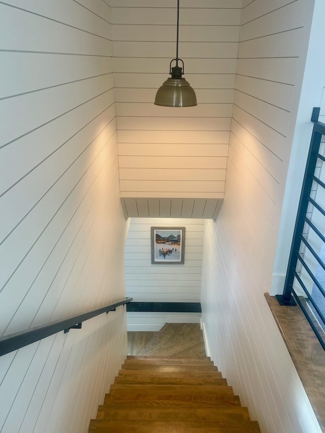 stairway with wood walls