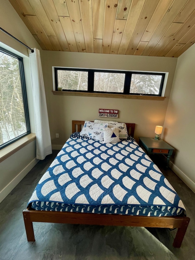 bedroom featuring lofted ceiling, dark carpet, and wood ceiling