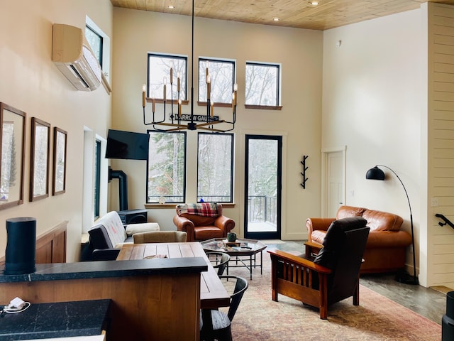 living room featuring a wall unit AC, a high ceiling, wooden ceiling, and an inviting chandelier