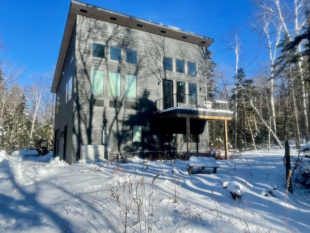 view of snow covered back of property