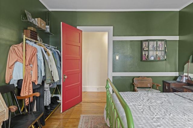 bedroom with crown molding and light hardwood / wood-style flooring