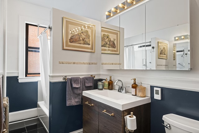 full bathroom featuring tile patterned floors, vanity, toilet, and shower / bathtub combination with curtain