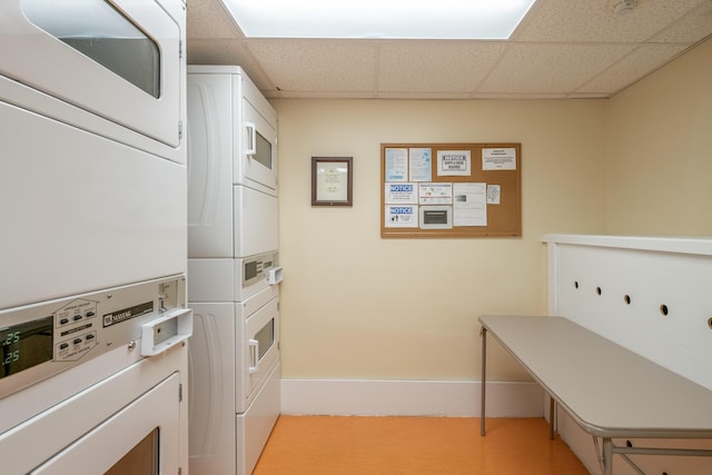 laundry area featuring stacked washer / drying machine