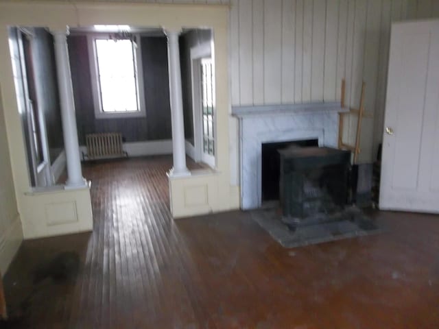 living room featuring dark wood-type flooring and radiator heating unit