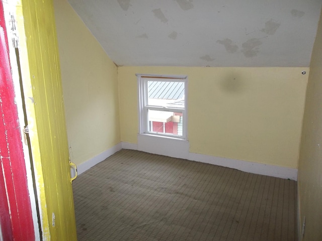 empty room featuring lofted ceiling and carpet floors