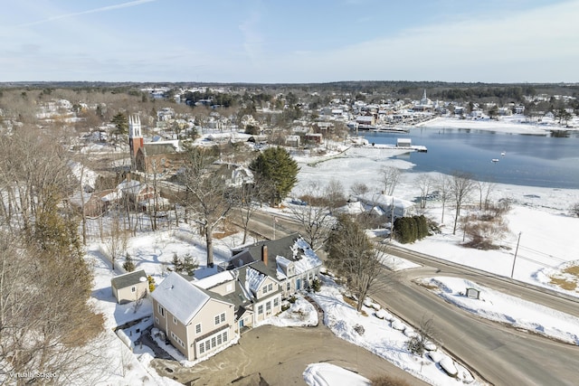 snowy aerial view with a water view