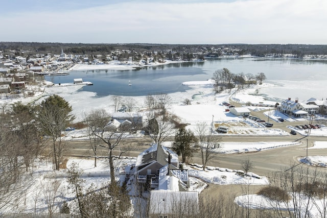 snowy aerial view featuring a water view