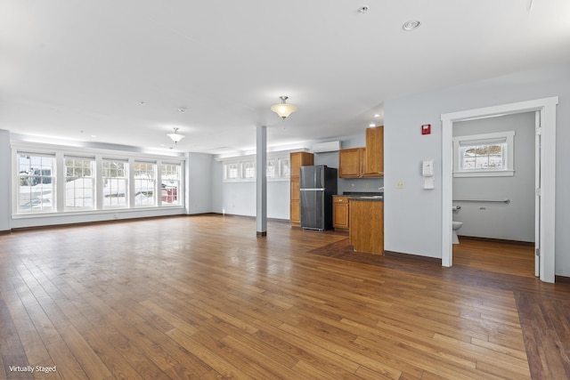 unfurnished living room with light wood-style flooring, baseboards, and recessed lighting