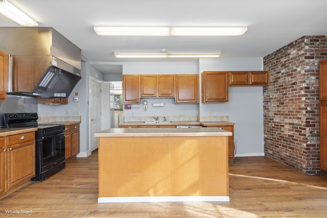 kitchen featuring light countertops, black range with electric stovetop, and a center island